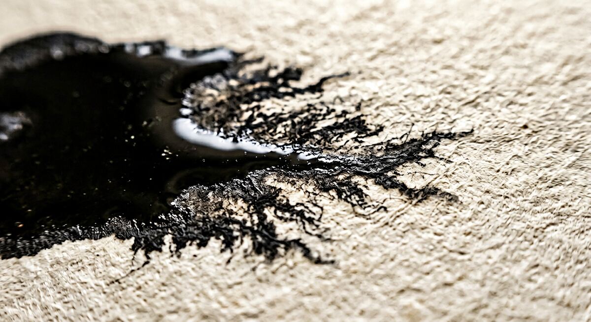 Close-up of wet ink bleeding into cream paper